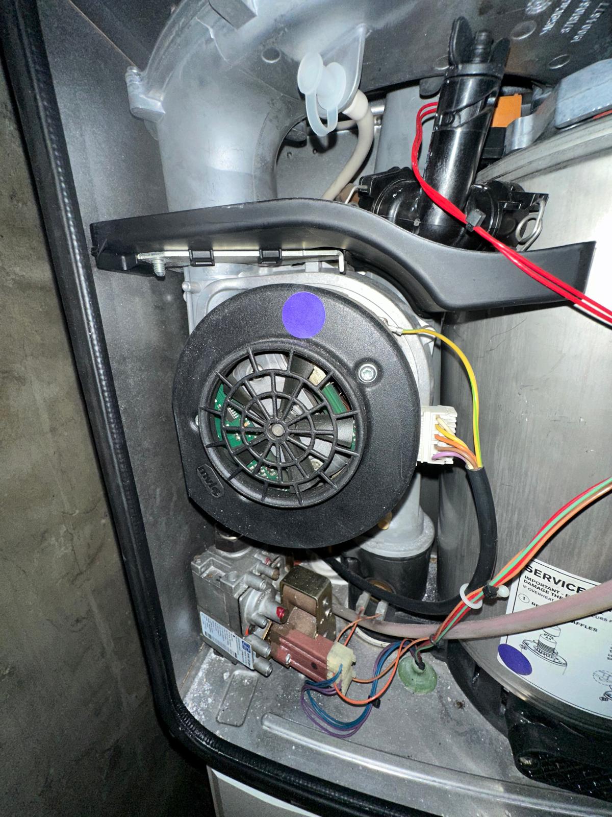 Boiler combustion fan close-up during a repair with service seal in place
